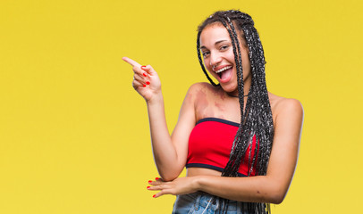 Sticker - Young braided hair african american with pigmentation blemish birth mark over isolated background with a big smile on face, pointing with hand and finger to the side looking at the camera.