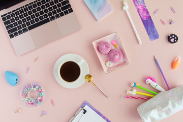 Wall Mural - School stationery with cup of tea with marshmallow and unicorn pen, lama pencil and laptop on a pink background. Back to school creative table desk with kawaii stationery, flatlay and top view