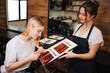© estradaanton - Young beautiful woman and hairdresser comparing her blonde hair with color hair from palette before correct coloring. Beauty, hair dyeing concept
