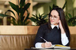 © proimagecontent - Brunette scholgirl learning something in the cafe atmosphere