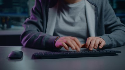 Aufkleber - Anonymous Software Developer / Hacker Sitting at His Desk and Typing on Computer Keyboard. Neon Technological Background. POV Camera Shot
