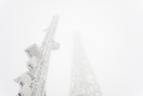 Fototapeta Boho - Frozen telecommunication technology tower texture graphics on a foggy winter day