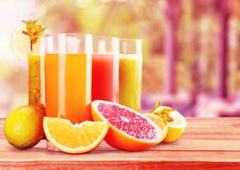 Tasty fruits and juice on wooden table