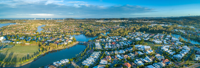 Wall Mural - Aerial panorama of luxury suburb on the Gold Coast at sunset.