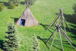 Straw wigwam on a glade on a sunny spring day. Wigwam type thatch huts .