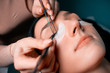 © Светлана Наклейщиков - Eyelash extension procedure close up. Beautiful woman with long eyelashes in a beauty salon. Lifestyle. Beauty and fashion. Personal care.