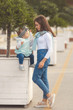 © Evgeniya Grande - Happy mother and daughter have fun and wearing a jeans clothes in city. Street style family look.