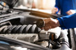 © Pixel-Shot - Male mechanic examining car in service center