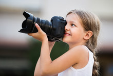 Girl Taking Pictures With Professional Camera Outdoors