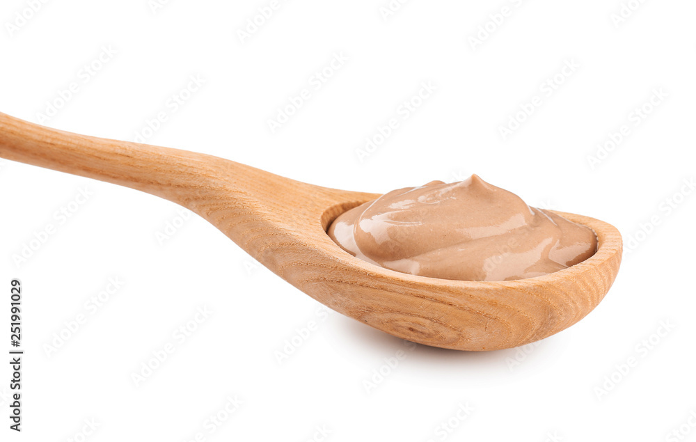 Spoon with tasty chocolate yogurt on white background