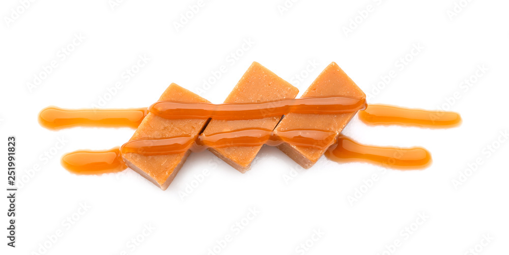 Tasty caramel candies on white background
