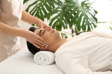 Poster - Man receiving face massage in beauty salon