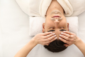 Poster - Man receiving face massage in beauty salon