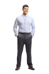 Young man in a shirt and trousers posing with hands in pocket