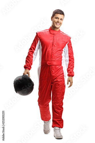 Cuadros en Lienzo Male car racer holding a helmet and walking towards the camera
