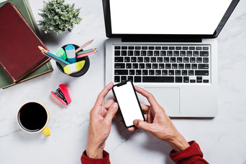 Wall Mural - flat lay, top view desk table.man using mobile phone at marble desk table with blank screen laptop c