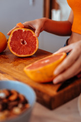 Wall Mural - Selective focus of a grapefruit half on the cutting board