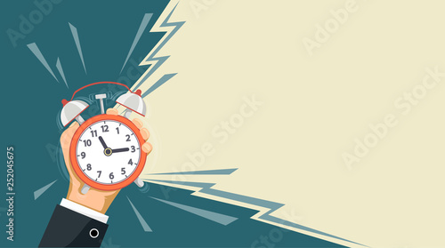 Fotografía Ringing alarm clock is in the hand of a man