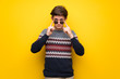 © luismolinero - Teenager man over yellow wall with glasses and surprised