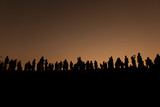 Fototapeta Konie - Silhouette of tourists looking at view with sunrise in the morning.