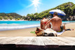© magdal3na - Desk of free space for your decoration. Beach landscape with two lovers on sand. Summer time.