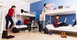 © JackF - Travelers communicating in hostel bedroom