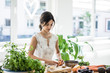 © Westend61 - Woman preparing healthy food in her kitchen