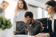 © JJ Studio - Stressed boss having problem at business meeting in office