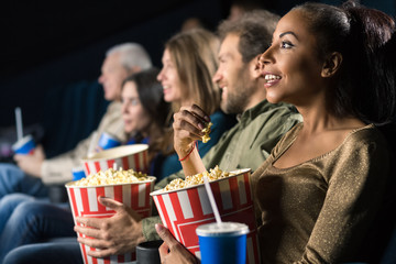 Multi ethnic group of mature people relaxing at the movie theatre