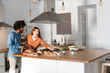 © Westend61 - Couple standing in kitchen, preparing dinner party