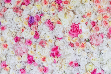  Flower texture background for wedding scene. White, lilac, pink, red roses and peonies. Artificial flowers on the wall. Banner for website.