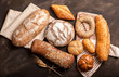 © nikilitov - Assortment of baked goods on dark background