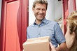 © Westend61 - Mature man receiving a package at his door