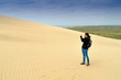 © Westend61 - Denmark, Jutland, woman taking pictures at Rubjerg Knude Lighthouse