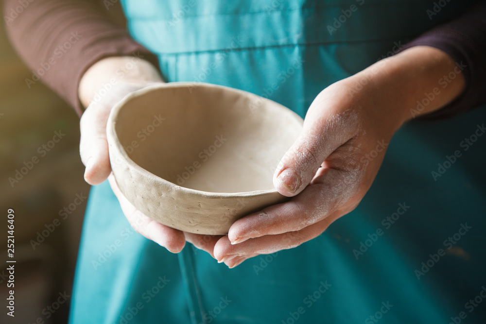 pottery making, hands holding ceramic bowl - obrazy, fototapety, plakaty 