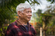 © meeboonstudio - Portrait of senior man standing in his garden.