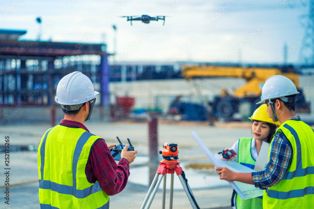 civil engineering flying drone over construction site survey for land ...