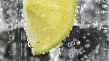 Close Up Lemon, Lime Slice In Soda Water Bubbles.