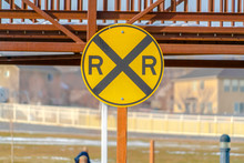 Railway Sign With A Snowy Bridge In The Background