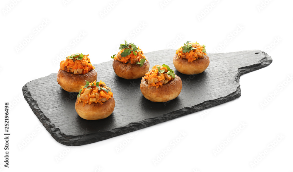 Slate plate with tasty stuffed mushrooms on white background