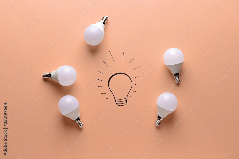 Creative composition with light bulbs on color background. Concept of uniqueness