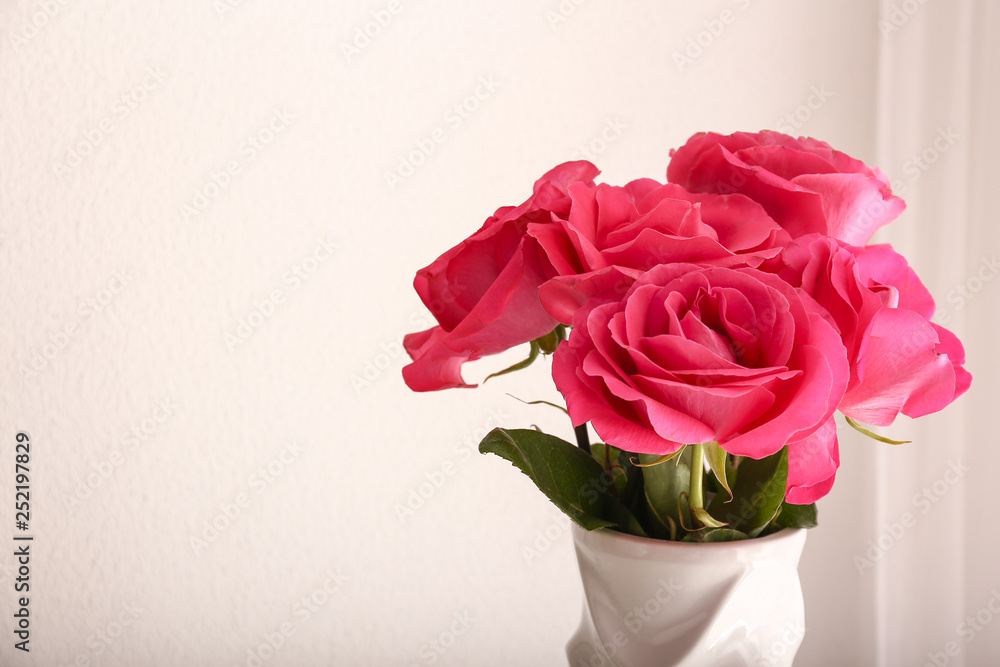 Bouquet of beautiful roses on light background