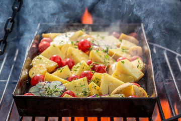 Wall Mural - Hot baked potatoes na grill with tomatoes and garlic