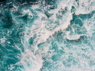 aerial top down shot of ocean or sea surf during the storm