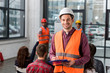 © LIGHTFIELD STUDIOS - Selective focus of happy fireman holding clipboard near coworker giving talk on briefing