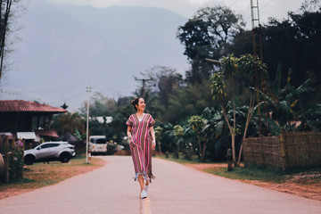 portrait of asian women in lanna uniform from thailand north by walking village countryside in outdoor mountain and nature with concept relaxing in travel and vacation