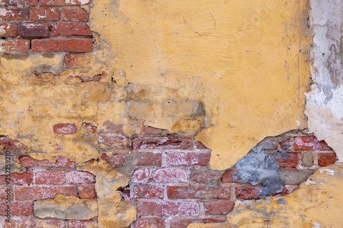 Photo Texture Of Old Brick Wall With Yellow Plaster
