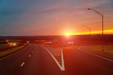 Country road with cloudy sky in the light of the dawn sunset