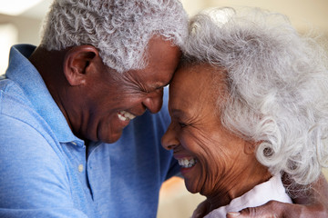 Wall Mural - Profile Shot Loving Senior Couple Head To Head At Home Together