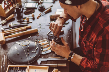 guy executing jewellery repair, close up side view photo, craftsmanship